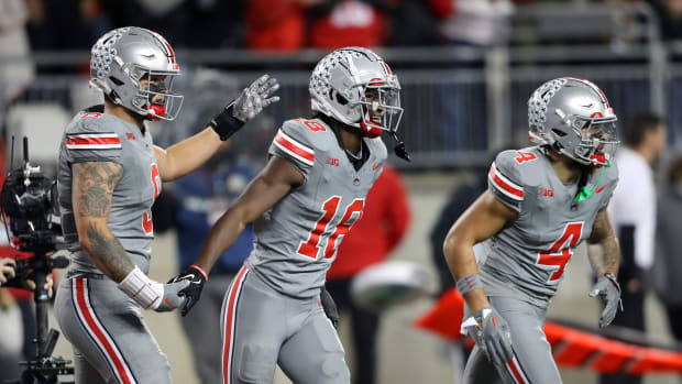 Ohio State Buckeyes wide receiver Marvin Harrison Jr. (18) celebrates the touchdown with tight end Cade Stover (8) and wide receiver Julian Fleming (4) during the first quarter against the Michigan State Spartans